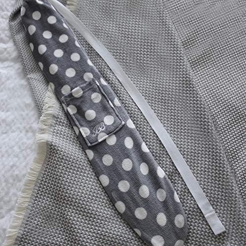 Yuyu Original long hot water bottle in grey polka-dot fleece cover, draped on a grey knit blanket.